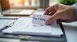 © Alex Pios - Person hand filing tax documents into a folder, focus on the documents labeled Tax Filing, modern office setting, soft natural lighting, clean and organized workspace