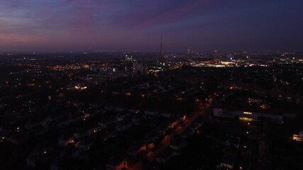 Wall Mural - flight over illuminated dark city in night or sunset