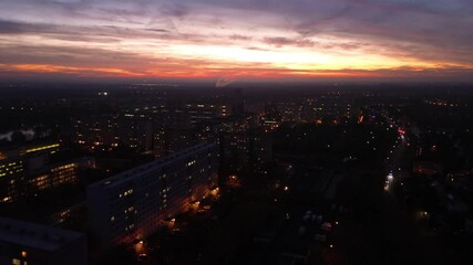 Wall Mural - flight over illuminated dark city in night or sunset
