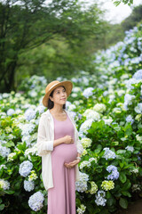 Wall Mural - Pregnant woman visit the flower farm garden