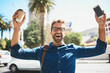 © peopleimages.com - Happy man, portrait and winning with phone in city for good news, career opportunity or accomplishment. Young, excited or male person with smile in joy for success, deal or offer in an urban town