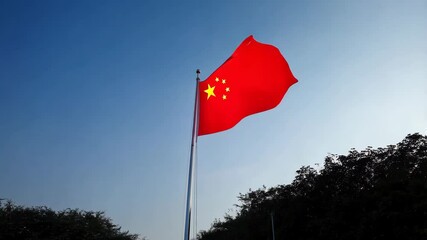 Wall Mural - Chinese flag waving in the air among blue sky