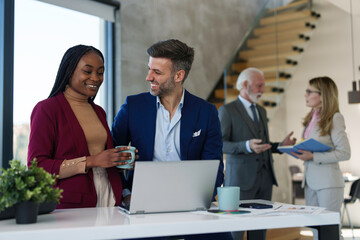 Focused view on a Caucasian male executive's hands expertly navigating a laptop keyboard; busy professionals networking in the background.