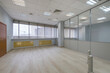 © alhim - A spacious office with a glass partition dividing the space. Panoramic window. The room is ready for the installation of furniture and equipment.