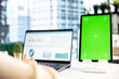 © DC Studio - Young business manager working with isolated copy space on her tablet, working on financial planning with data analytics on laptop. Developing a strategy to increase funding for success.