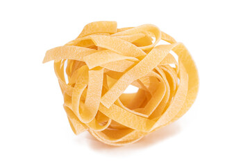 One Classic Italian Raw Egg Fettuccine - Isolated on White Background. Dry Twisted Uncooked Pasta. Italian Culture and Cuisine. Raw Golden Macaroni Pattern - Isolation