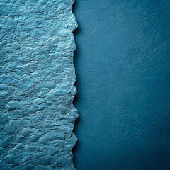 Poster - A piece of textured blue paper displays a torn edge, revealing a smooth, darker blue surface underneath. The contrast highlights the beauty of paper art and design materials.