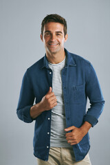 Poster - Happy, fashion and portrait of man in studio with denim for casual style, clothes and cool outfit. Positive attitude, joy and isolated person with confidence, pride and smile on gray background