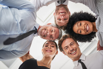 Below, huddle and portrait of business people in office together for solidarity or unity as group. Circle, face and smile of employee team in corporate workplace for collaboration or motivation