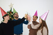 © naraichal - A joyful group of friends and families celebrating Christmas together with smiles and New Year hats