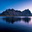 © Shavy - serene icelandic mountain landscape reflected in calm water at twilight