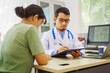 © NanSan - A male doctor sits at a desk in a hospital,reviewing a female patient’s medical history.He provides compassionate advice for depression, addressing symptoms like sadness,hopelessness, anger, anxiety
