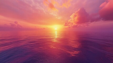 A vibrant sunset over the ocean with soft pink and orange clouds.