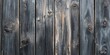 © Nijat - The texture of gray black wooden planks shows subtle indications of wear and aging, creating a close up view that highlights these characteristics.