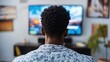 © Rufat - Afro American man engaged in watching a weather report on TV while enjoying a moment indoors. The Afro American man focuses intently on the weather report, with space for text.