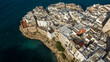 © Stefano Tammaro - Aerial view of houses, apartments and buildings in the historic center of Polignano a Mare, in the province of Bari, Puglia, Italy. The town is built on a cliff overlooking the Mediterranean Sea.