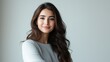 © Robert Kneschke - Serene portrait of a Middle Eastern woman in her 20s with long wavy hair and a calm expression