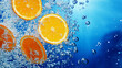 © Magic Kiddo - Orange slices submerged in sparkling water with backlight creating refreshing summer vibe