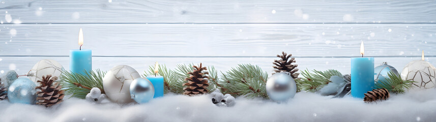 Wall Mural - blue christmas candles, balls and pine cones in a row with spruce branches covered with snow and sno