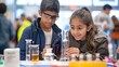 © Galib - Two kids, a boy and a girl, are looking at a beaker at a science fair.