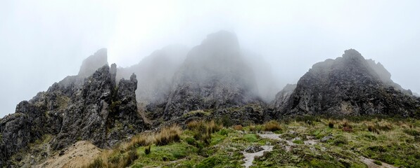 Poster - Misty mountain landscape with rugged rocks.