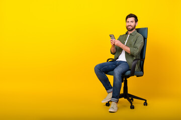 Aufkleber - Full length portrait of nice young man sit chair hold phone empty space wear shirt isolated on yellow color background