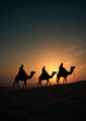 © David Angkawijaya - three silhouette of the Magi are riding camels in the desert at sunset