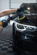 © alones - Professional man polishing black car. Car care and polishing. Scratch removal. Detailing