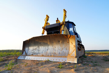 Poster - Dozer at construction site, utility trenching. Earth-moving machinery. Bulldozer at road construction. Earth-moving equipment at road work, land clearing, grading, pool excavation, utility trenching.