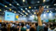 © ryker - hand raised in crowded conference room, symbolizing engagement and participation. blurred background shows audience and presentation screen, creating dynamic atmosphere