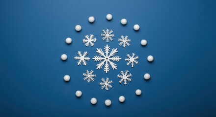 Wall Mural - Christmas wreath made of decorative snowflakes and snowballs on blue background, creating a festive winter holiday scene