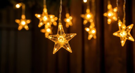 Poster - Star-shaped fairy lights emit a warm, inviting glow, hanging against a dark background, perfect for festive celebrations or cozy evenings