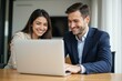 © SimpleDesignStudio - Professional Business Couple Working Together on Laptop in Modern Office Setting, Ideal for Business and Marketing Materials