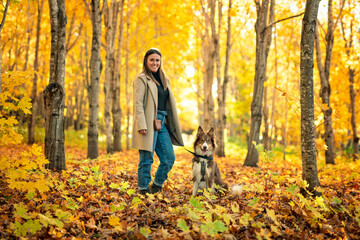 Loving woman with her shepherd Australian on fall season