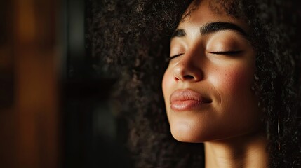 An attractive woman with curly hair sings with closed eyes in a recording studio, creating an intimate atmosphere. The photo captures her passion for music and includes photo style copy space.