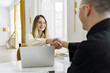 © muse studio - A Professional Woman and Man Shake Hands During a Business Meeting in a Bright, Modern Office Space