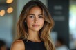 © Vesna - confident young hispanic woman standing in a sleek office radiating professionalism and success engaged with her tablet symbolizing empowerment in the business world