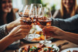 © siripimon2525 - Happy Family Toasting with Wine in a Cozy Setting