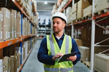 portrait of a smiling young warehouse worker working in a cash and carry wholesale store