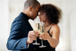 © Anastasiya - Close up of cheerful african american couple toasting with white wine, celebrating anniversary. High quality photo
