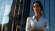 © Johannes - Businesswoman with arms crossed standing by modern building in city