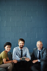 Poster - Portrait, smile and tablet with business people on brick wall in office for collaboration or meeting. Diversity, happy and teamwork with employee group on sofa in professional workplace for research