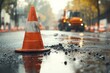 © Michael - Orange traffic cones signaling road works on wet asphalt road