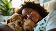 © Lens Legacy - A joyful woman nestled on a sofa with two playful puppies, capturing the warmth and ease of a leisurely afternoon in a beautifully sunlit living space.