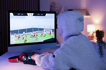 Wall Mural - Woman playing video game with keyboard at table indoors