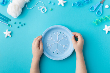 Wall Mural - Snowflake made from wool threads on blue paper plate Christmas ideas for kindergarten diy