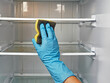 © TAMER YILMAZ - woman cleaning the inside of a dirty refrigerator. close-up.