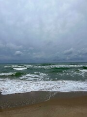 Wall Mural - cloudy grey seascape, waved sea horizon, windy at the sea, empty beach