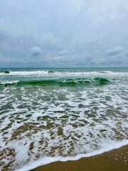 Wall Mural - cloudy grey seascape, waved sea horizon, windy at the sea, empty beach