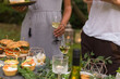 © Karniewska - Friends enjoying wine tasting with al fresco brunch in garden